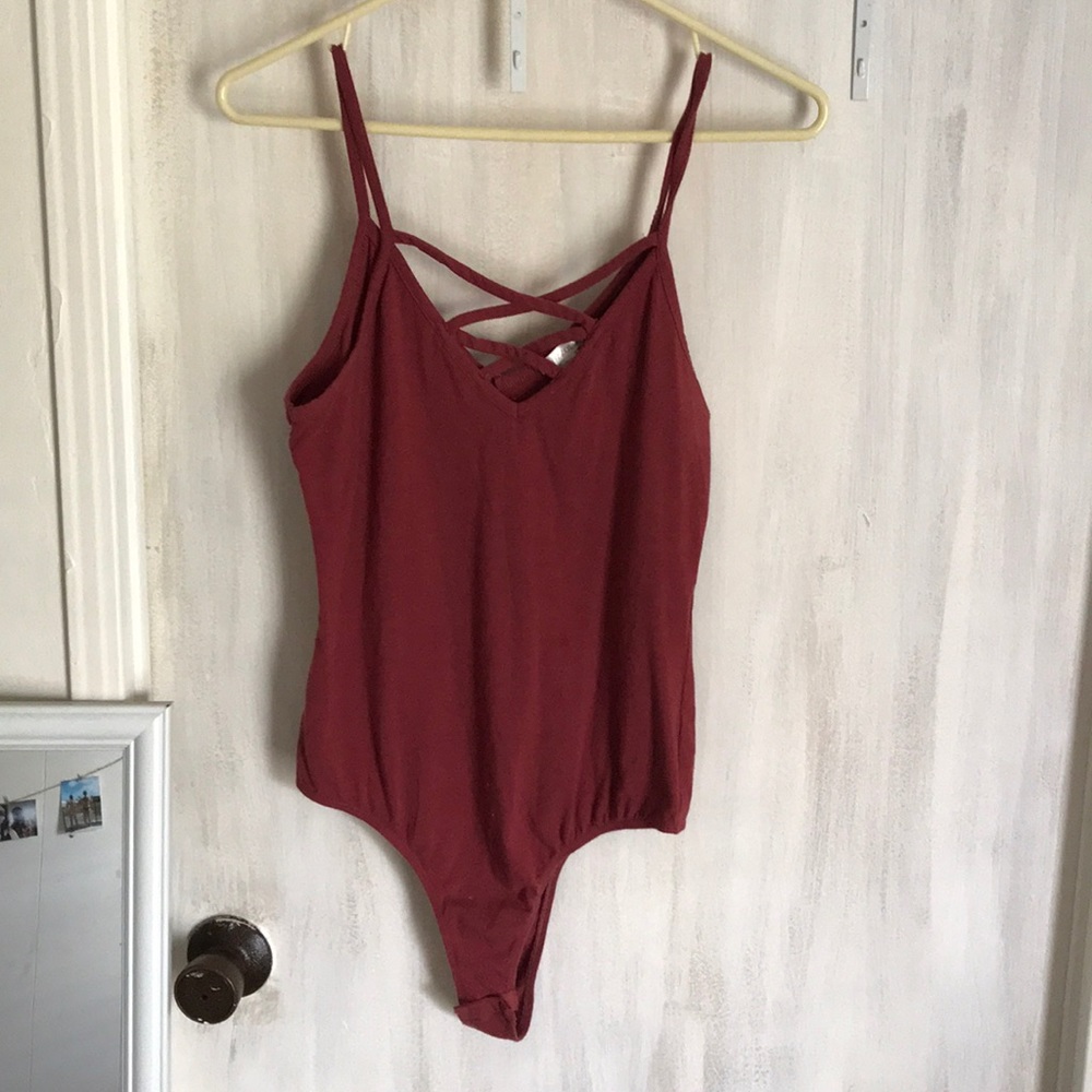 Red body suit with criss cross chest.